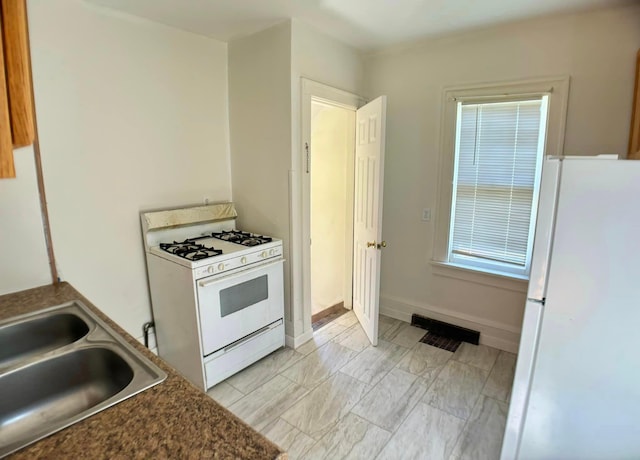 kitchen with white appliances and sink