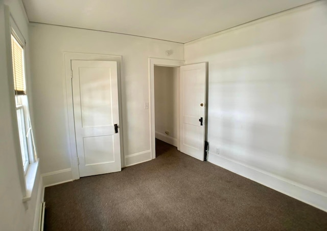 unfurnished bedroom featuring dark colored carpet