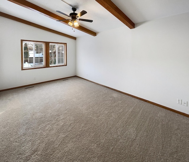 empty room featuring carpet floors, vaulted ceiling with beams, ceiling fan, and baseboards