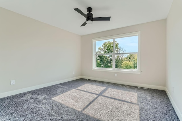 spare room featuring ceiling fan and carpet flooring