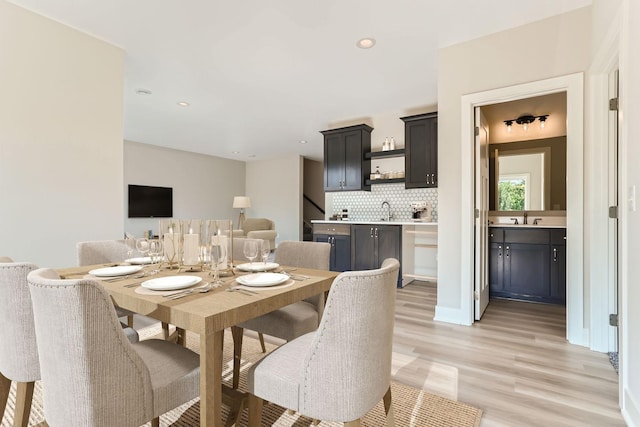 dining room with sink and light hardwood / wood-style flooring