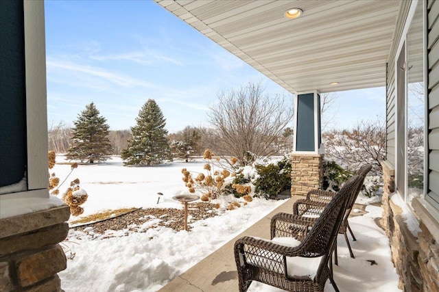 snow covered patio with covered porch