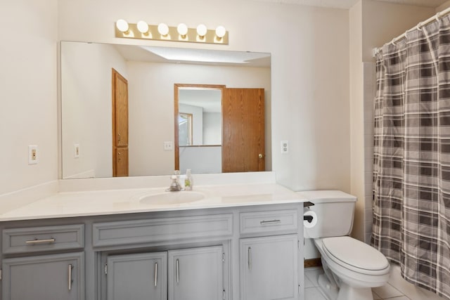 full bathroom featuring toilet, curtained shower, tile patterned flooring, and vanity