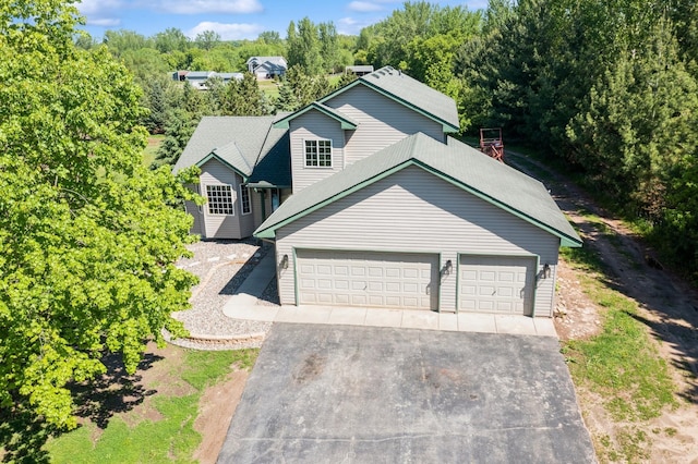 8075 211th Ave NW, Nowthen, MN 55330 - traditional-style house featuring driveway and an attached garage