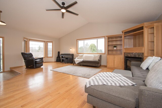 8075 211th Ave NW, Nowthen, MN 55330 - living room featuring a ceiling fan, a fireplace, light wood finished floors, and high vaulted ceiling