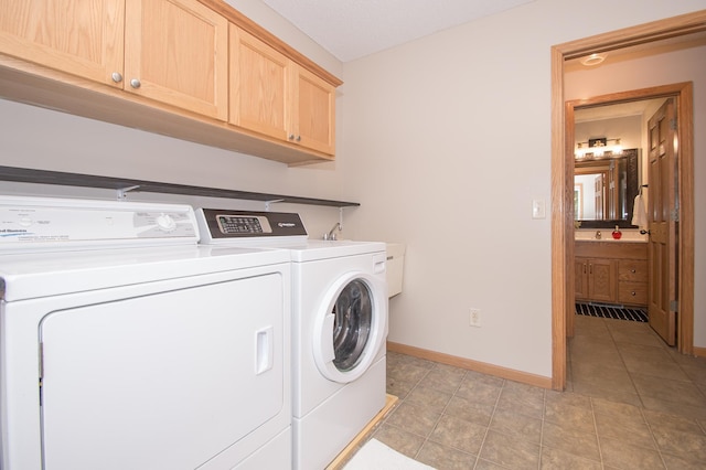 8075 211th Ave NW, Nowthen, MN 55330 - laundry room with independent washer and dryer, cabinet space, baseboards, and light tile patterned floors