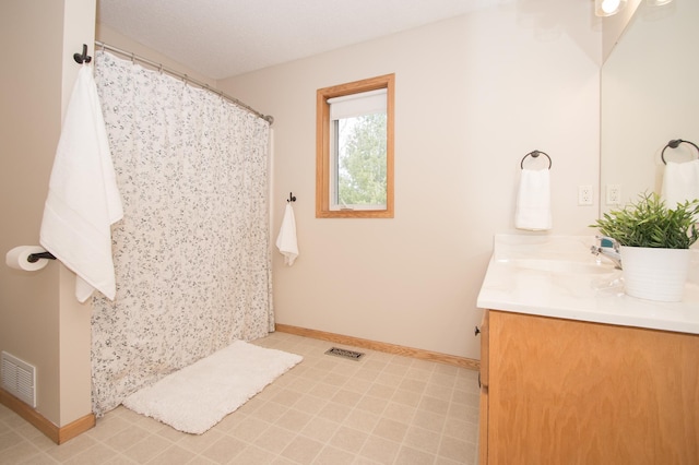 8075 211th Ave NW, Nowthen, MN 55330 - bathroom with vanity, baseboards, tile patterned floors, and a shower with curtain