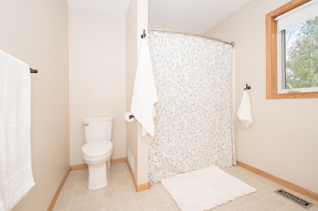 8075 211th Ave NW, Nowthen, MN 55330 - bathroom with toilet, curtained shower, and baseboards
