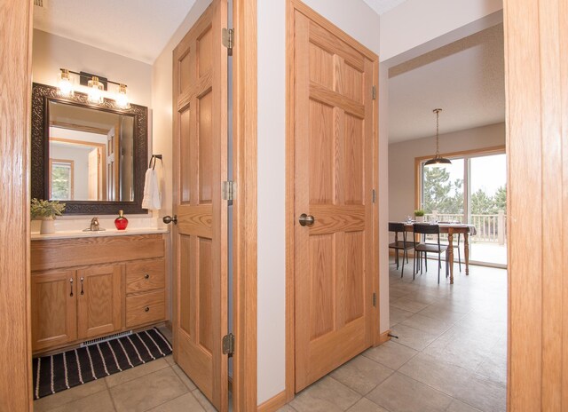 8075 211th Ave NW, Nowthen, MN 55330 - bathroom with vanity and tile patterned flooring
