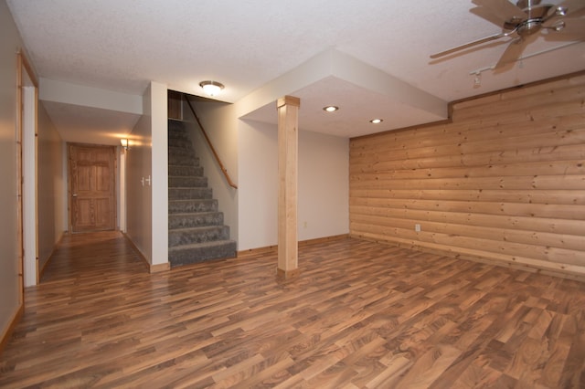 8075 211th Ave NW, Nowthen, MN 55330 - finished below grade area featuring wood finished floors, a textured ceiling, wooden walls, stairway, and recessed lighting
