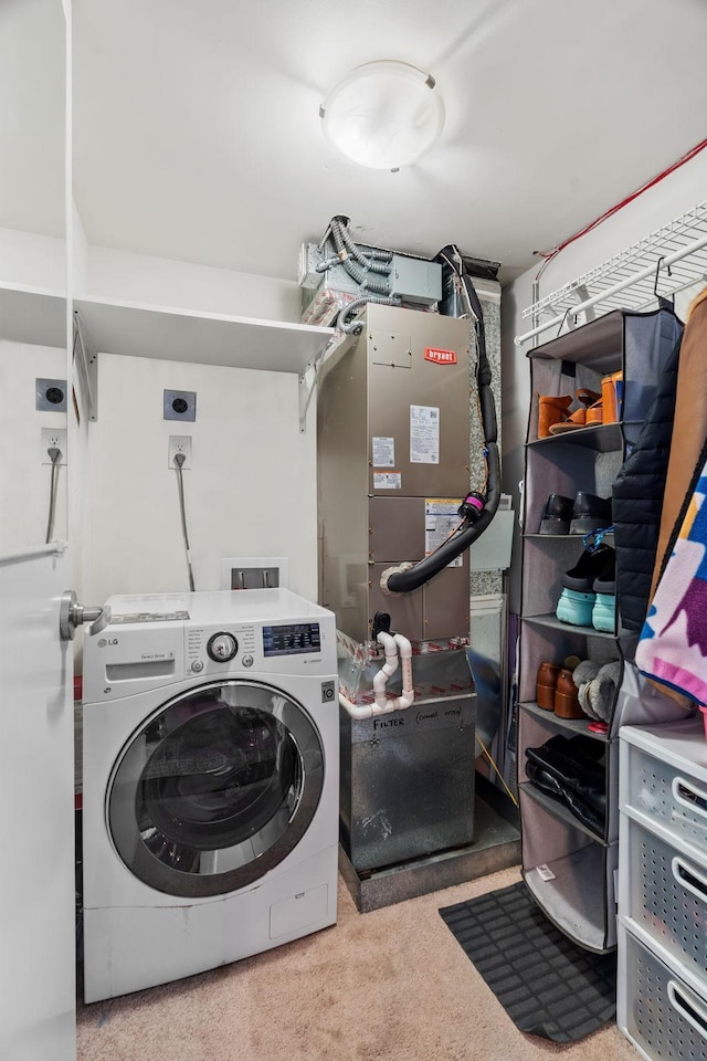 laundry area with heating unit, washer / dryer, and laundry area