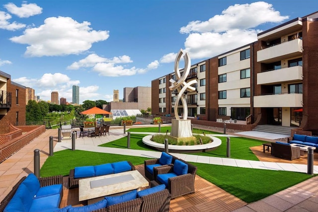 view of property's community with an outdoor living space, a view of city, and a patio area