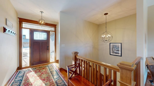 foyer with a notable chandelier and hardwood / wood-style flooring