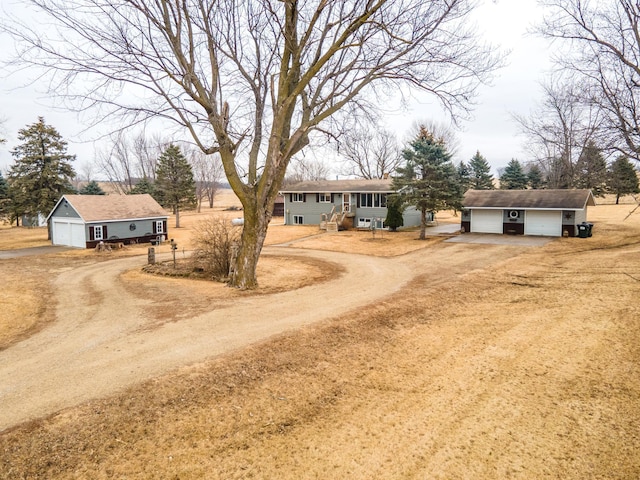 exterior space featuring dirt driveway and an outdoor structure