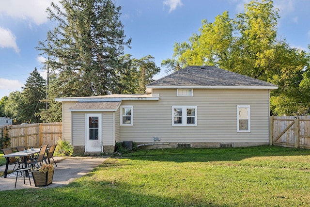 back of property with a lawn and a patio area