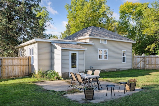 rear view of house with a yard and a patio