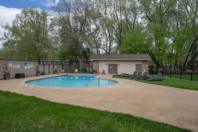 pool with a patio area, fence, and french doors