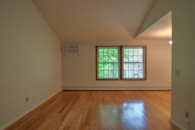 empty room with light wood-type flooring, lofted ceiling, an AC wall unit, and a baseboard heating unit