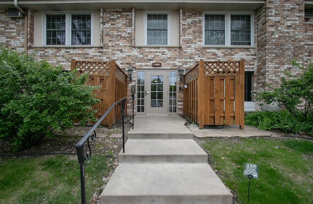 entrance to property featuring brick siding