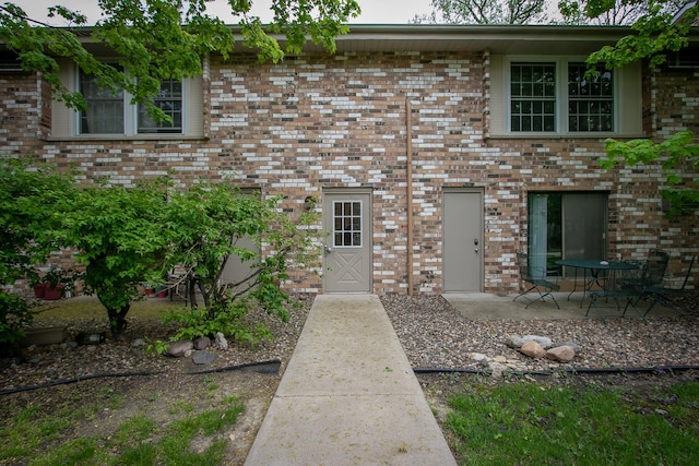 view of front of property with a patio area and brick siding