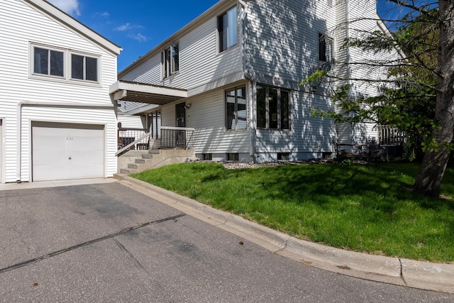 exterior space featuring a yard and an attached garage