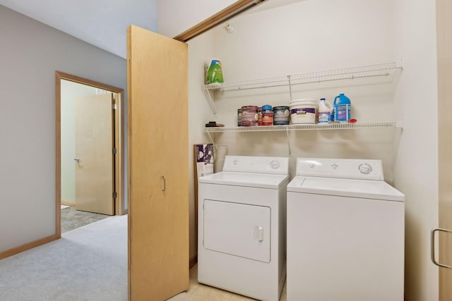 laundry area featuring laundry area, baseboards, light colored carpet, and independent washer and dryer