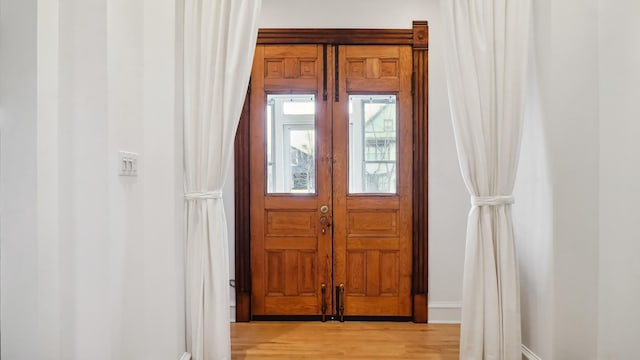 entryway featuring light wood-style flooring and baseboards