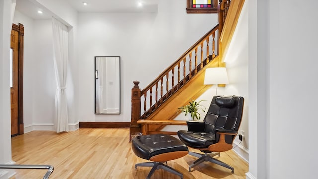 living area featuring baseboards and wood finished floors