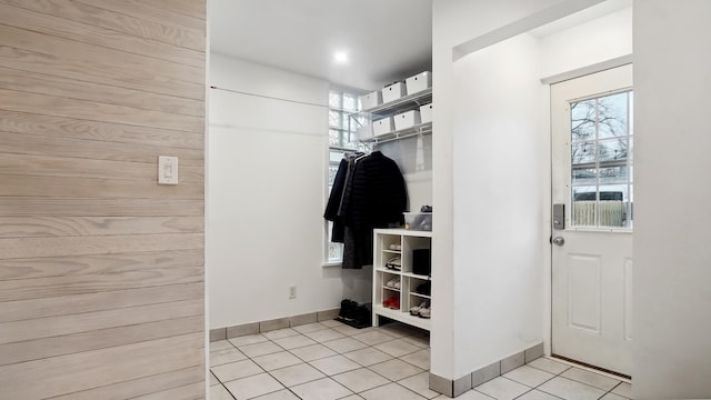 mudroom with light tile patterned floors and baseboards