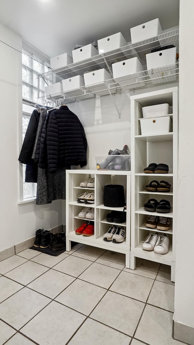 mudroom with light tile patterned floors and baseboards