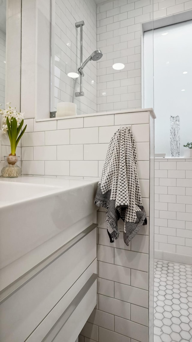 bathroom with tile walls and walk in shower