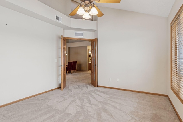 unfurnished room featuring baseboards, visible vents, and light colored carpet