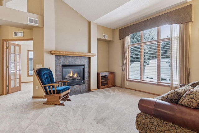 living room with light carpet, a fireplace, visible vents, and lofted ceiling