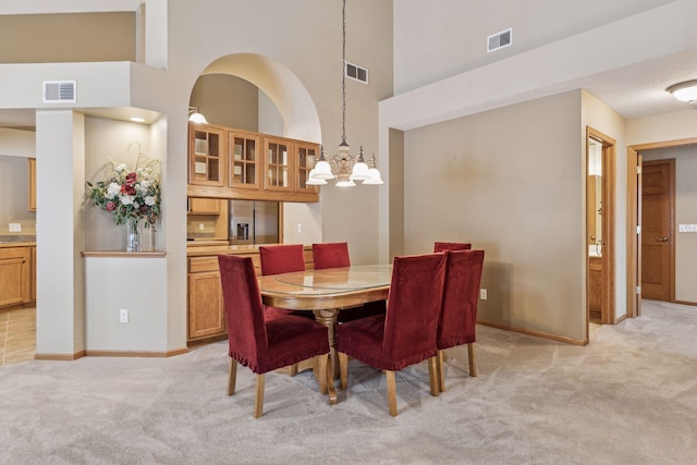 dining area featuring visible vents and light carpet