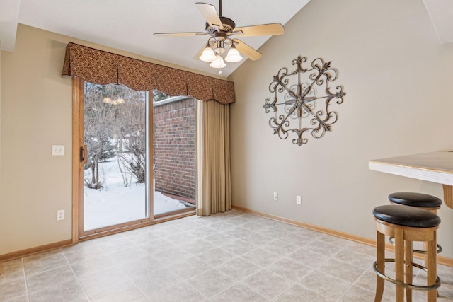 unfurnished dining area with lofted ceiling, a wealth of natural light, and baseboards