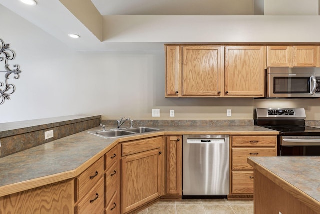 kitchen with light tile patterned floors, appliances with stainless steel finishes, a sink, and recessed lighting