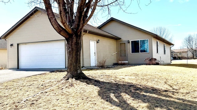 ranch-style house featuring an attached garage and concrete driveway