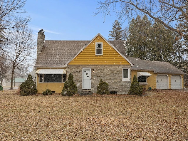 230 Mcleod Ave W, Winsted, MN 55395 - view of front of property featuring a chimney, stone siding, roof with shingles, and a garage