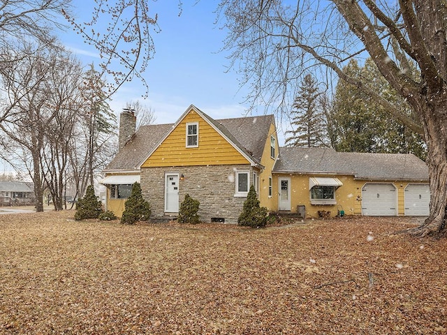 230 Mcleod Ave W, Winsted, MN 55395 - view of front facade featuring a chimney, a garage, and stone siding
