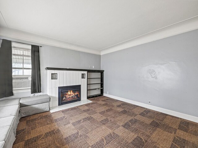 230 Mcleod Ave W, Winsted, MN 55395 - unfurnished living room featuring a fireplace with flush hearth, dark colored carpet, baseboards, and cooling unit