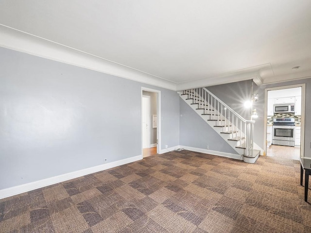 230 Mcleod Ave W, Winsted, MN 55395 - unfurnished living room with stairway, carpet, baseboards, and ornamental molding
