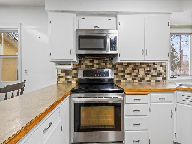 230 Mcleod Ave W, Winsted, MN 55395 - kitchen with appliances with stainless steel finishes, white cabinets, decorative backsplash, and light countertops