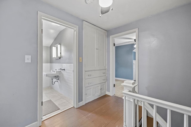 230 Mcleod Ave W, Winsted, MN 55395 - hall with wood-type flooring, tile walls, a wainscoted wall, and baseboards