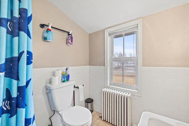 230 Mcleod Ave W, Winsted, MN 55395 - bathroom with radiator heating unit, tile walls, wainscoting, toilet, and tile patterned floors