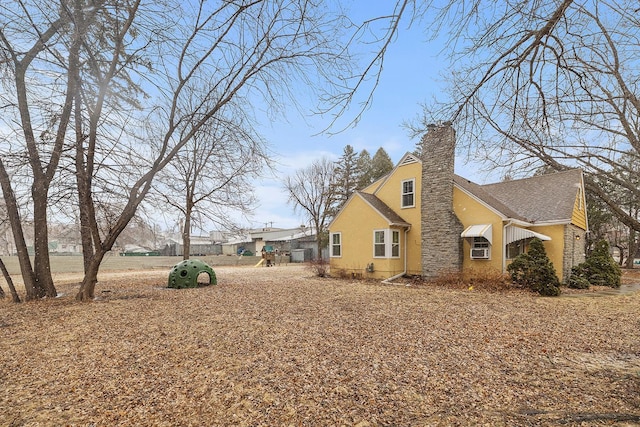 230 Mcleod Ave W, Winsted, MN 55395 - view of home's exterior featuring a chimney and stucco siding