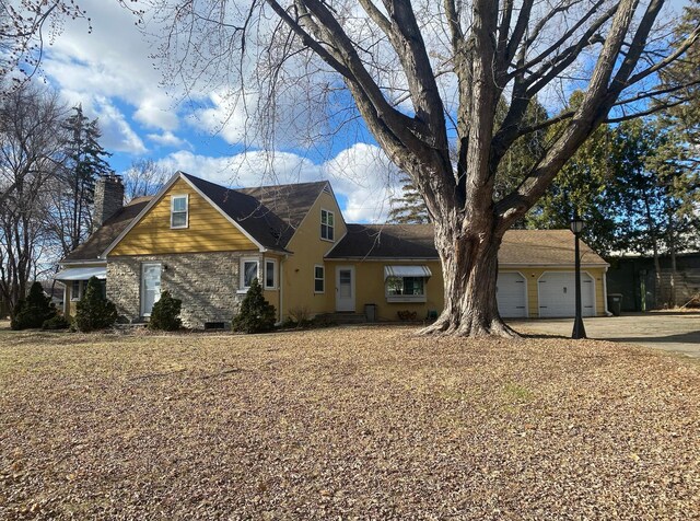 230 Mcleod Ave W, Winsted, MN 55395 - traditional home with a chimney, an attached garage, and concrete driveway