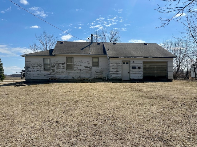 rear view of house featuring a garage