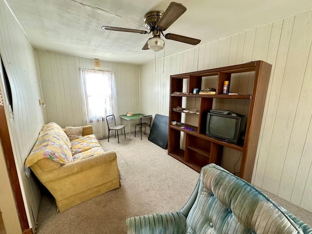 carpeted living room with a ceiling fan