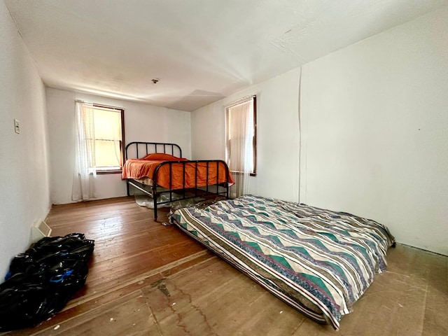 bedroom with hardwood / wood-style floors