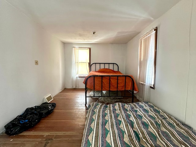 bedroom with visible vents and wood-type flooring